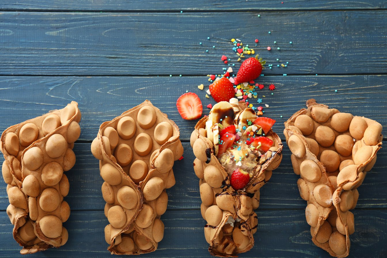 Delicious Sweet Bubble Waffles on  Wooden Table